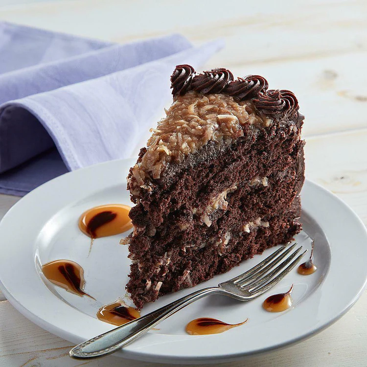Chocolate cake slice with coconut-pecan topping