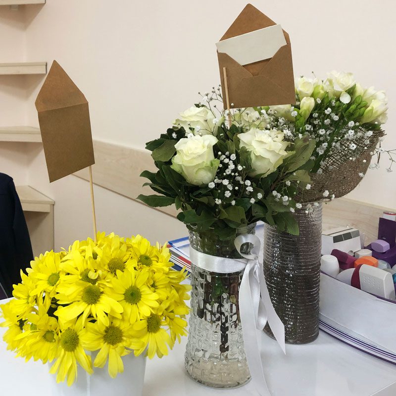 Group of flower bouquets with greeting card on office desk