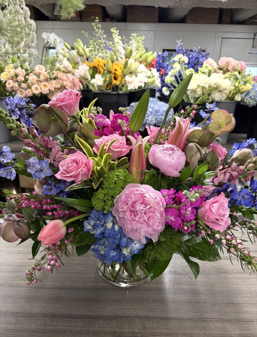 Pink and blue mixed floral bouquet in vase