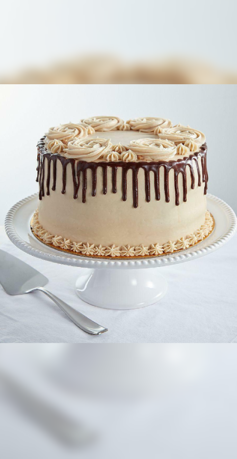 Round chocolate drip cake with piped rosettes