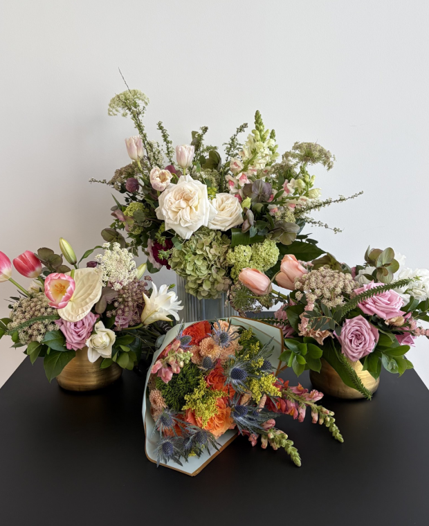 Assorted pastel floral bouquets on black table