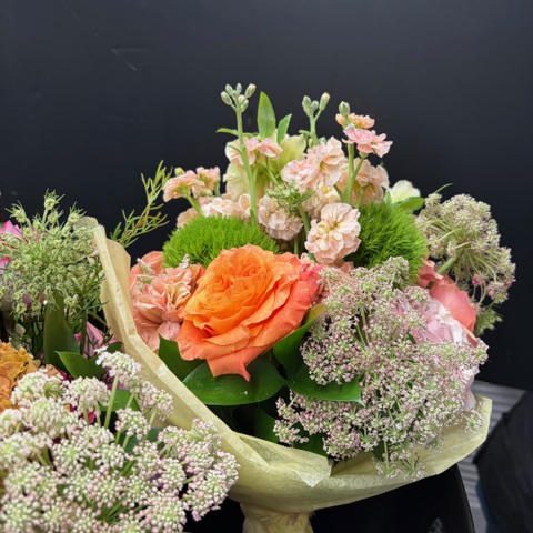 Orange rose bouquet with pastel filler flowers