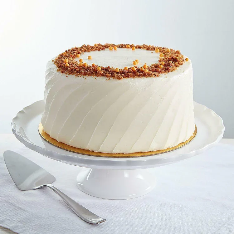 White frosted cake with crumb topping