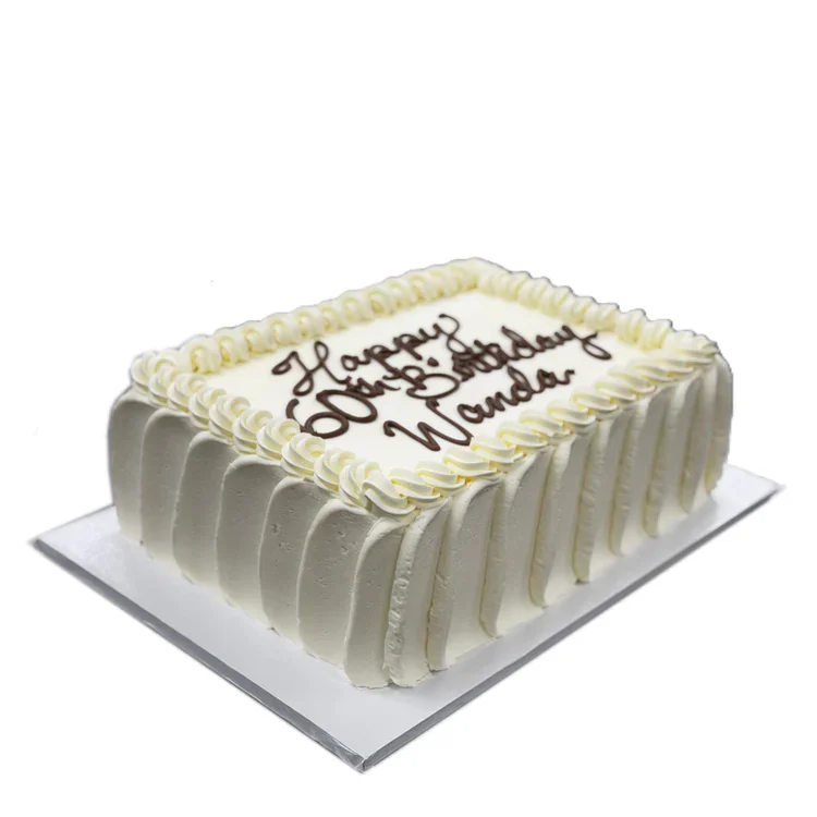 White frosted rectangular birthday cake with writing