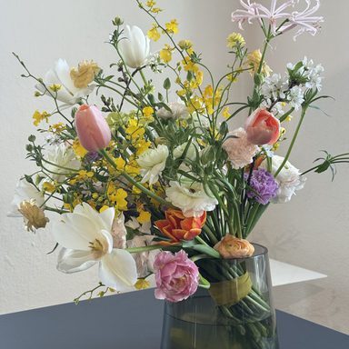 Artistic modern flower bouquet in designer florist shop with colorful spring blossoms and tulips