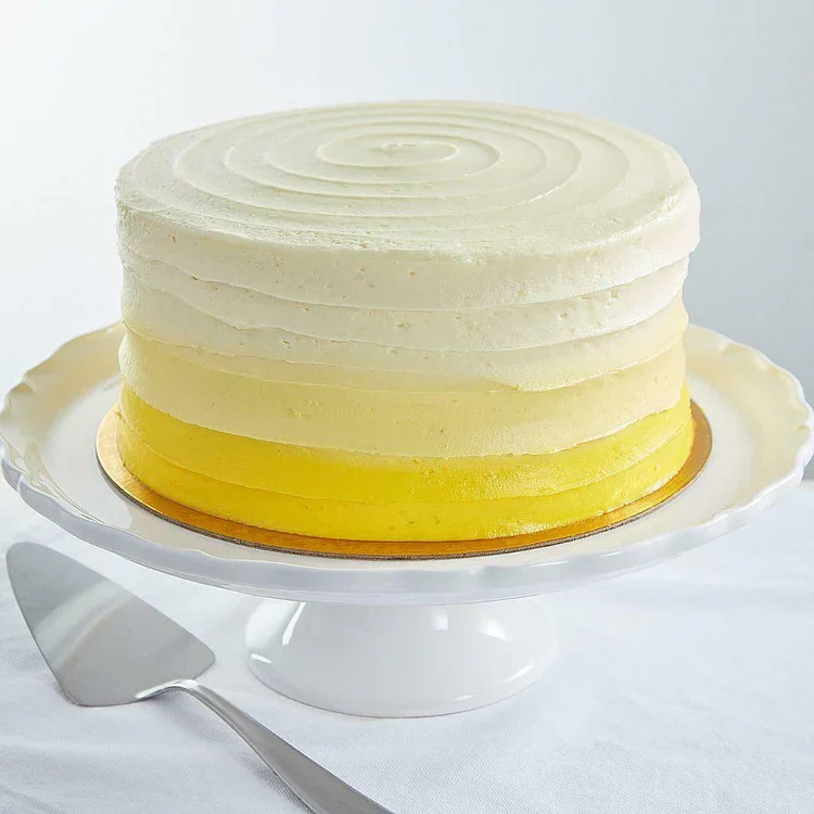 White and yellow frosted layer cake
